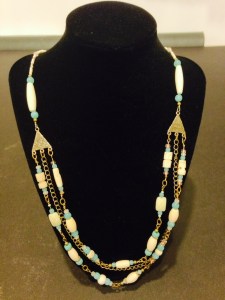 This handmade necklace is a wearable art piece that is made of: Bone Hairpipe and Carved Bone Beads, Amazonite, Glass, Copper and Antique Brass Beads by Joan Turecki