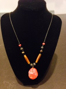 This handmade necklace is inspired by the colors of Northwest Coast First Nations art and is made from: Coral, Carved Bone, Horn, and Glass Beads by Joan Turecki