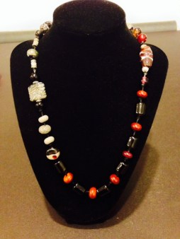 This handmade necklace can be worn in a varaiety of ways, allowing you to display different aspects of the piece depending on your mood and clothing. This wearable art piece has balance rather than symmetry and is made of: Venetian Handmade Glass and Smoky Quartz Beads by Joan Turecki $50
